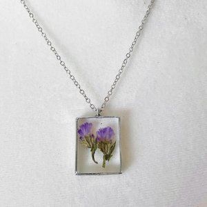 Purple floral botanical flower resin necklace in dark silver bezel